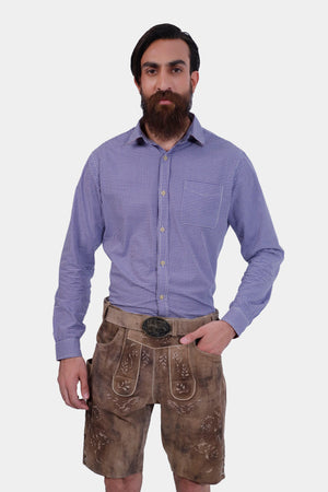 A man wearing the Alpine Eagle Lederhosen in Mountain Chestnut, paired with a blue checkered shirt, showcasing the front view.