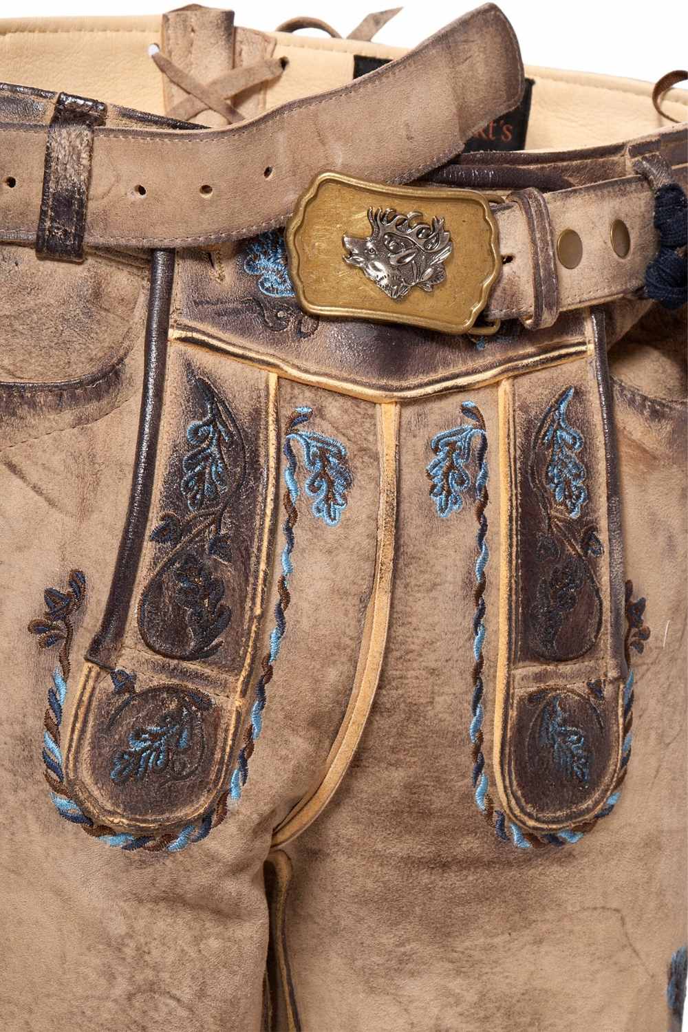 Close-up of german short lederhosen with intricate stitching and vibrant blue floral embroidery. These traditional german leather shorts feature a durable design with an antique brass belt buckle