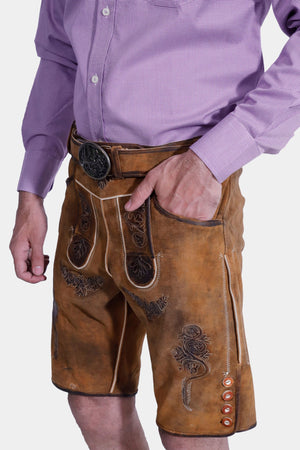 Closed side view of a man in Brecht Classic Lederhosen, Burnished Bronze with intricate embroidery and stylish buttons.