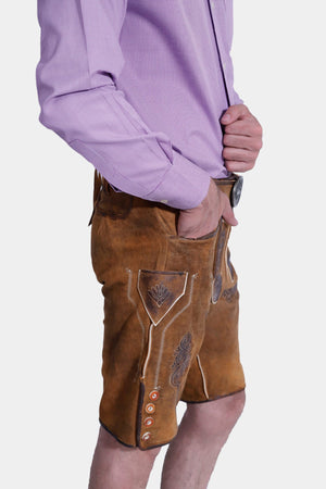 Closed side view of a man in Brecht Classic Lederhosen, Burnished Bronze with intricate embroidery and stylish buttons.
