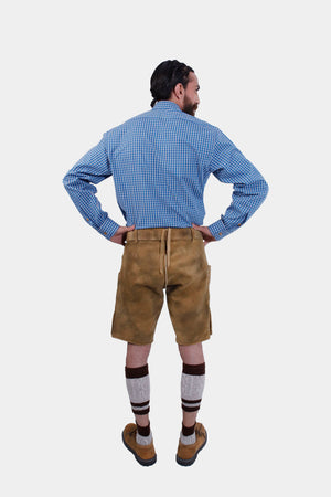 Full-length back view of a man in traditional lederhosen, highlighting the adjustable back waistband and overall fit.