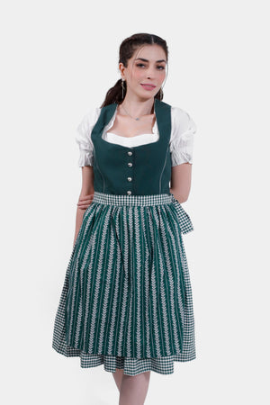 Model wearing a green Dirndl dress with a checkered apron, posing with a slight smile.