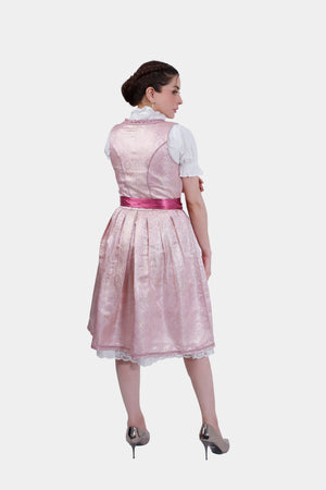 Back view of the pink dirndl dress showing the pleated skirt and satin ribbon tied in a bow around the waist.