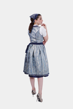Back view of the Dirndl dress, displaying the seamless design and pleated skirt with a navy blue waist tie.