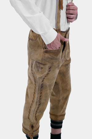 Side view of a man in a blue checkered shirt and tan Ernst Happel Bundhosen, showcasing detailed embroidery on the side.