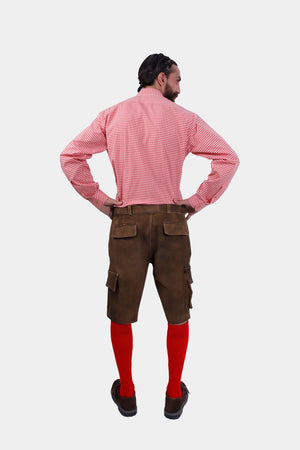 A full-length back view of the man in brown leather lederhosen and red checkered shirt, with red knee-high socks and brown shoes. 