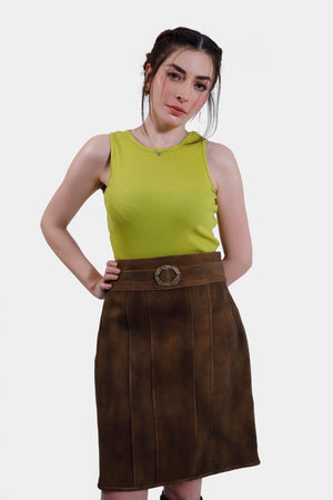 Women wearing Gastein Lederhosen Skirt in Desert Amber, goat suede leather, knee-length design, tailored fit. Belt not included.