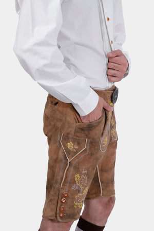 Side view of a man wearing Lederhosen with suspenders, displaying the traditional Bavarian attire from the front.