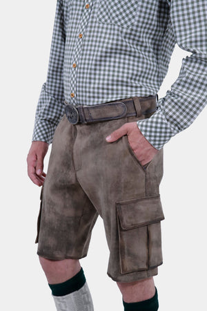 Close-up view focusing on the waist and pocket area of a man wearing grey leather lederhosen and a grey and white checkered shirt. The man has his right hand in the pocket, highlighting the belt and detailed stitching on the lederhosen.