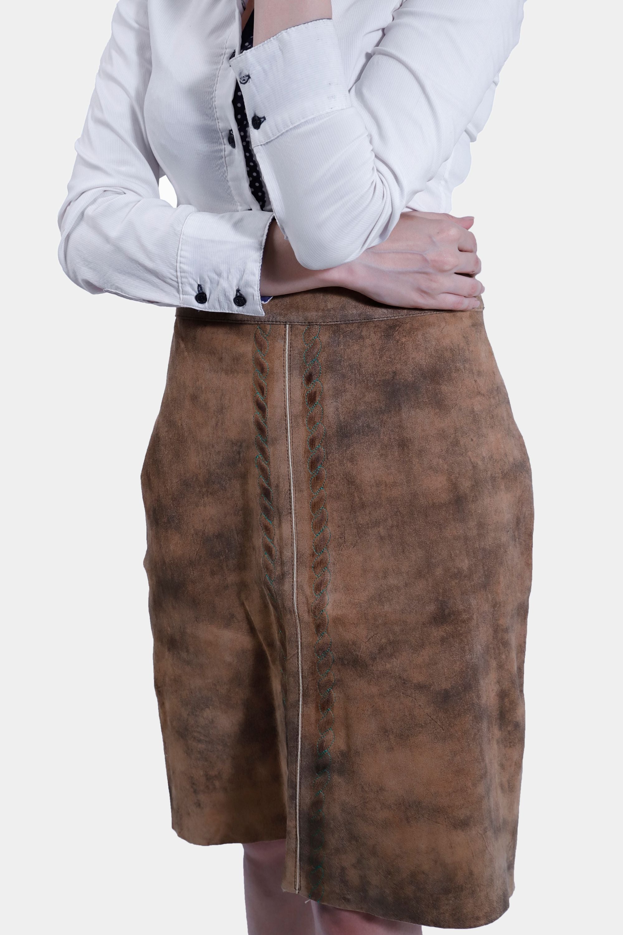 Side close-up view of women wearing a traditional brown leather Karoline Lederhosen Skirt with subtle embroidery.