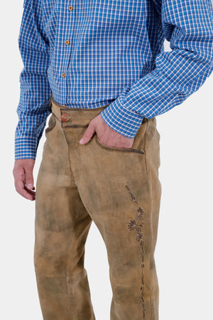 Closed side view of a man wearing Kochelsee Lederhosen Long pants paired with light blue checkered shirt
