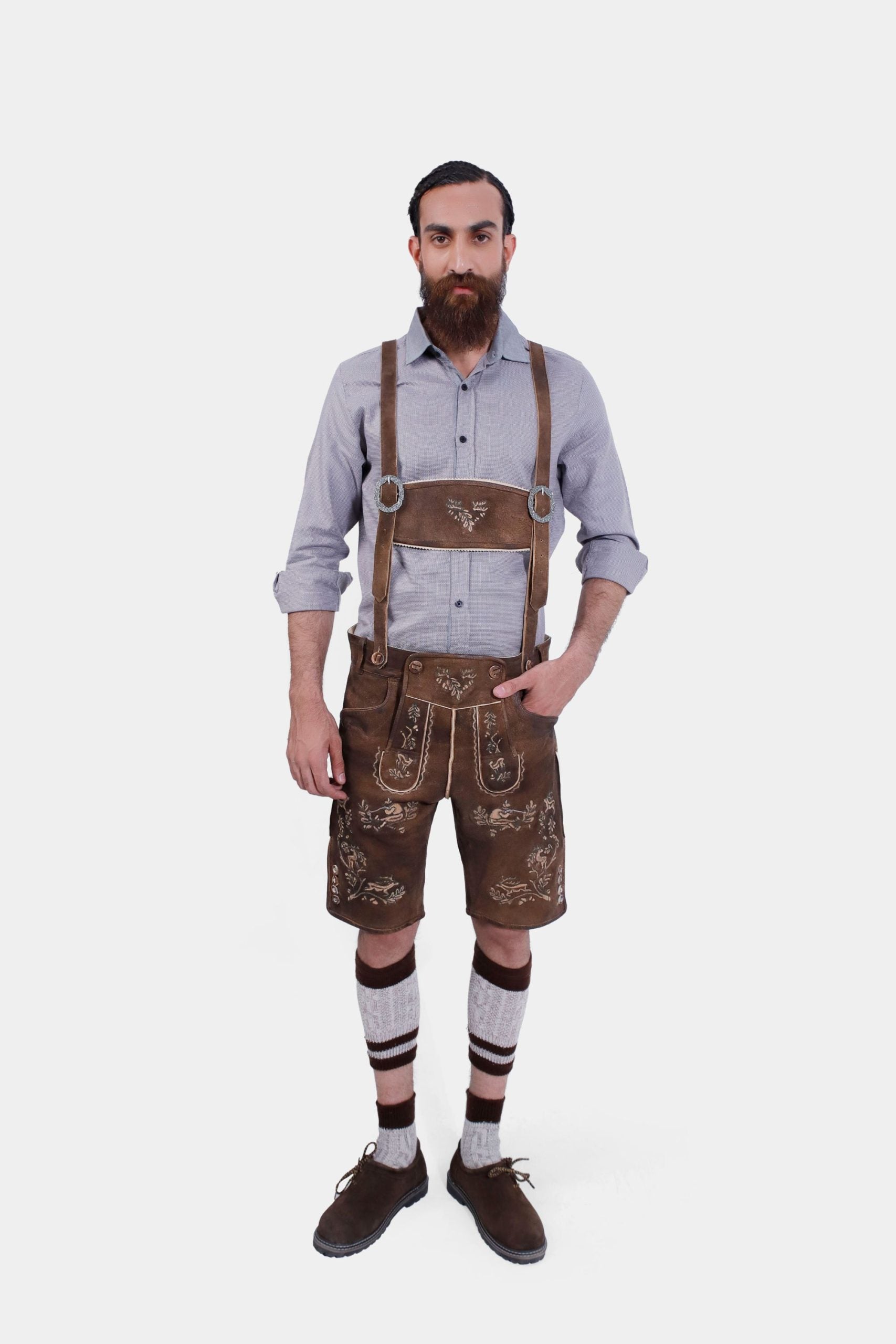 "Man wearing traditional Lederhosen with a light gray shirt, dark brown leather suspenders featuring white floral embroidery, named 'Matthaus Suspender.