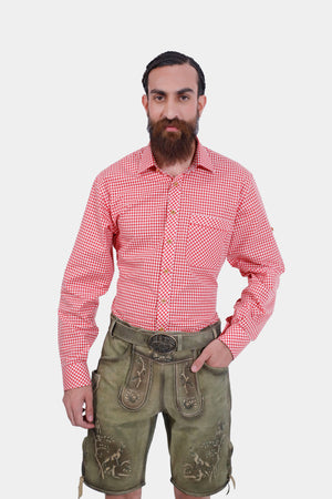 Close-up of traditional German lederhosen with detailed embroidery and red checkered shirt."
