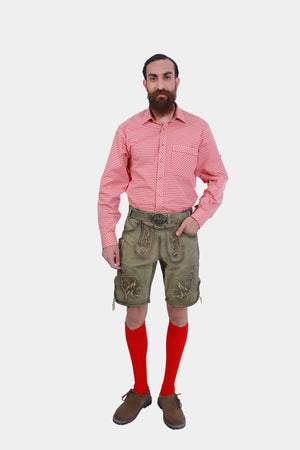 A man with a beard wearing a red checkered shirt, green embroidered Lederhosen, and red knee-high socks, standing against a white background.