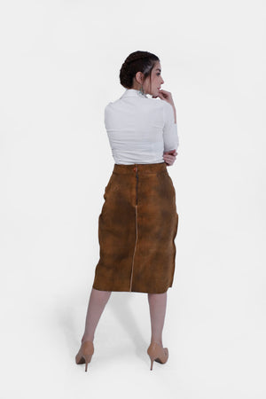Back view of women wearing a traditional brown leather Nena Lederhosen Skirt with white embroidery, buttons, and side pockets, paired with a white blouse with a polka-dotted inner collar