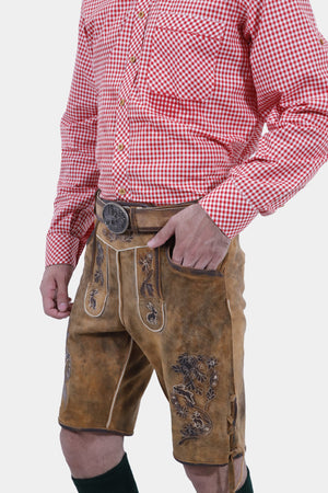 Right Side profile of a man dressed in Oktoberfest Tulsa Lederhosen and a red gingham shirt, highlighting the side ties and embroidery of the lederhosen."