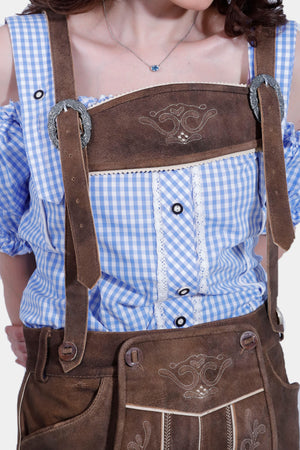 Close-up of a woman wearing the Paula Beer Lederhosen Outfit, highlighting the detailed embroidery on the leather shorts and the delicate ruffles on the off-shoulder blue and white checkered blouse.
