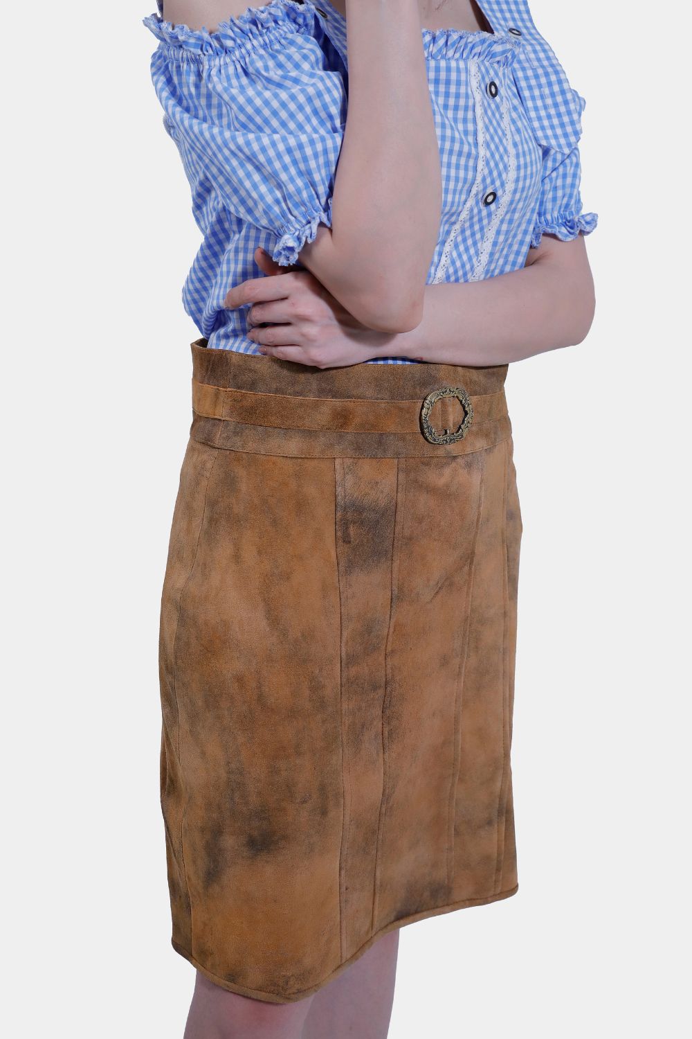 Model in Rustic Dream Lederhosen Skirt, Sunset Bronze goat suede, with blue gingham top.