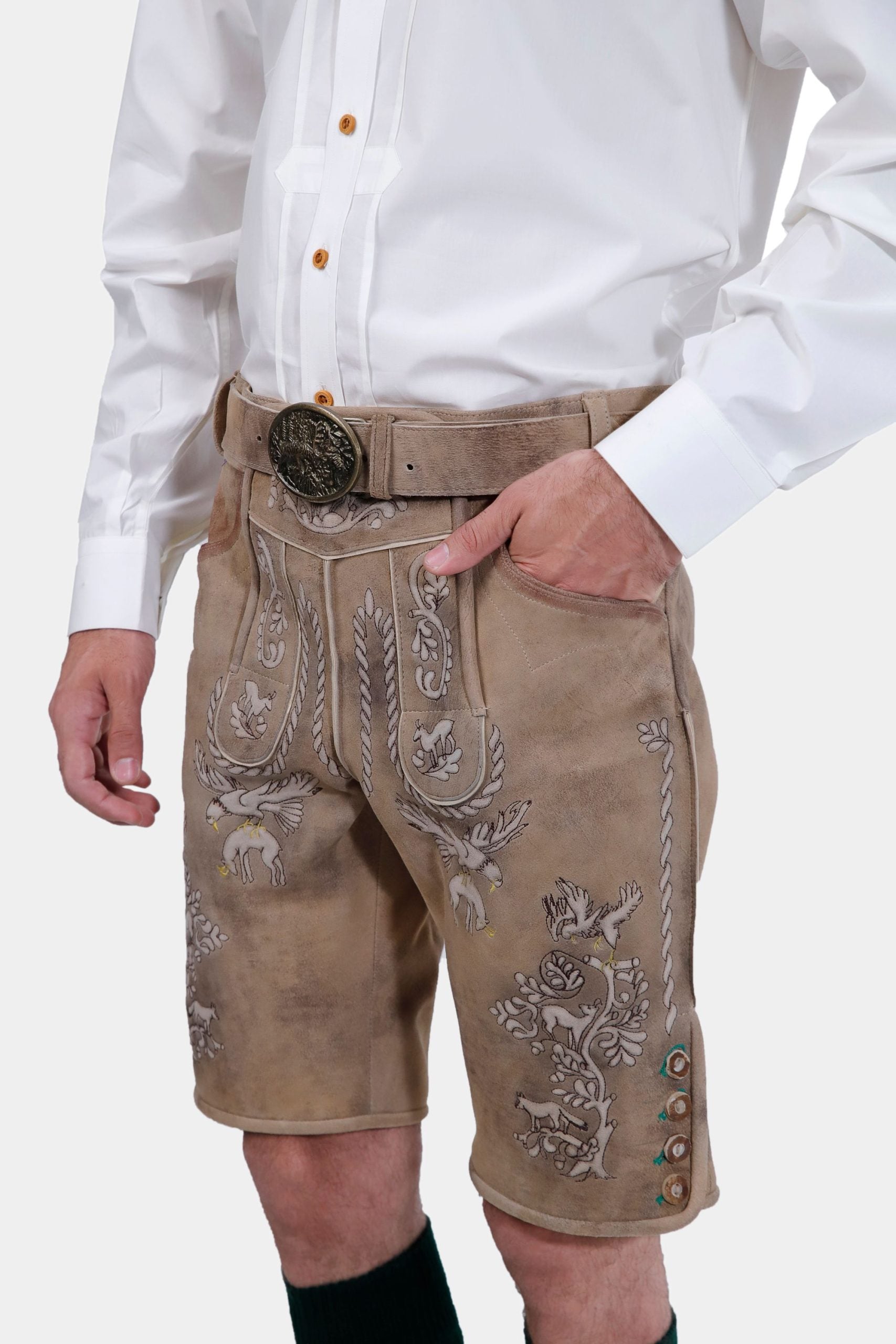 Close-up of the man's torso, highlighting the detailed embroidery on the beige Lederhosen and the ornate belt buckle. His white shirt is neatly tucked in.