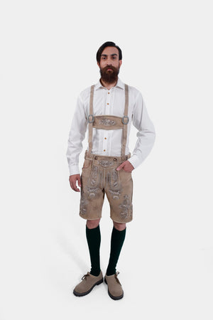 Man wearing Schweinsteiger Lederhosen with a white shirt and green knee-high socks.