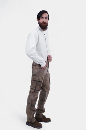 complete side view of a man wearing stamberg cargo long lederhosen paired with plain white shirt