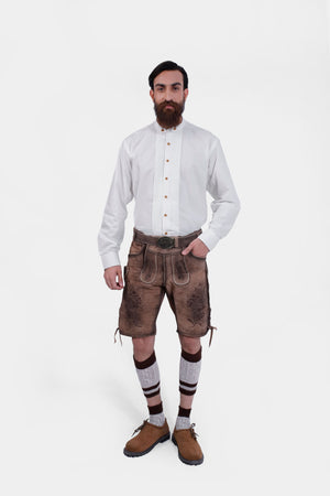 Man wearing Timber Trail Lederhosen in Caramel Earth with natural embroidery, goat suede leather, and multiple pockets.