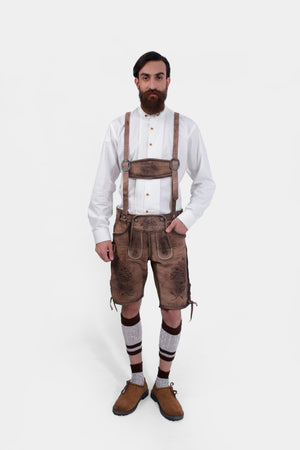 Complete front view of a man wearing Timber Trail Lederhosen in Caramel Earth with suspenders in natural embroidery, goat suede leather, and multiple pockets.