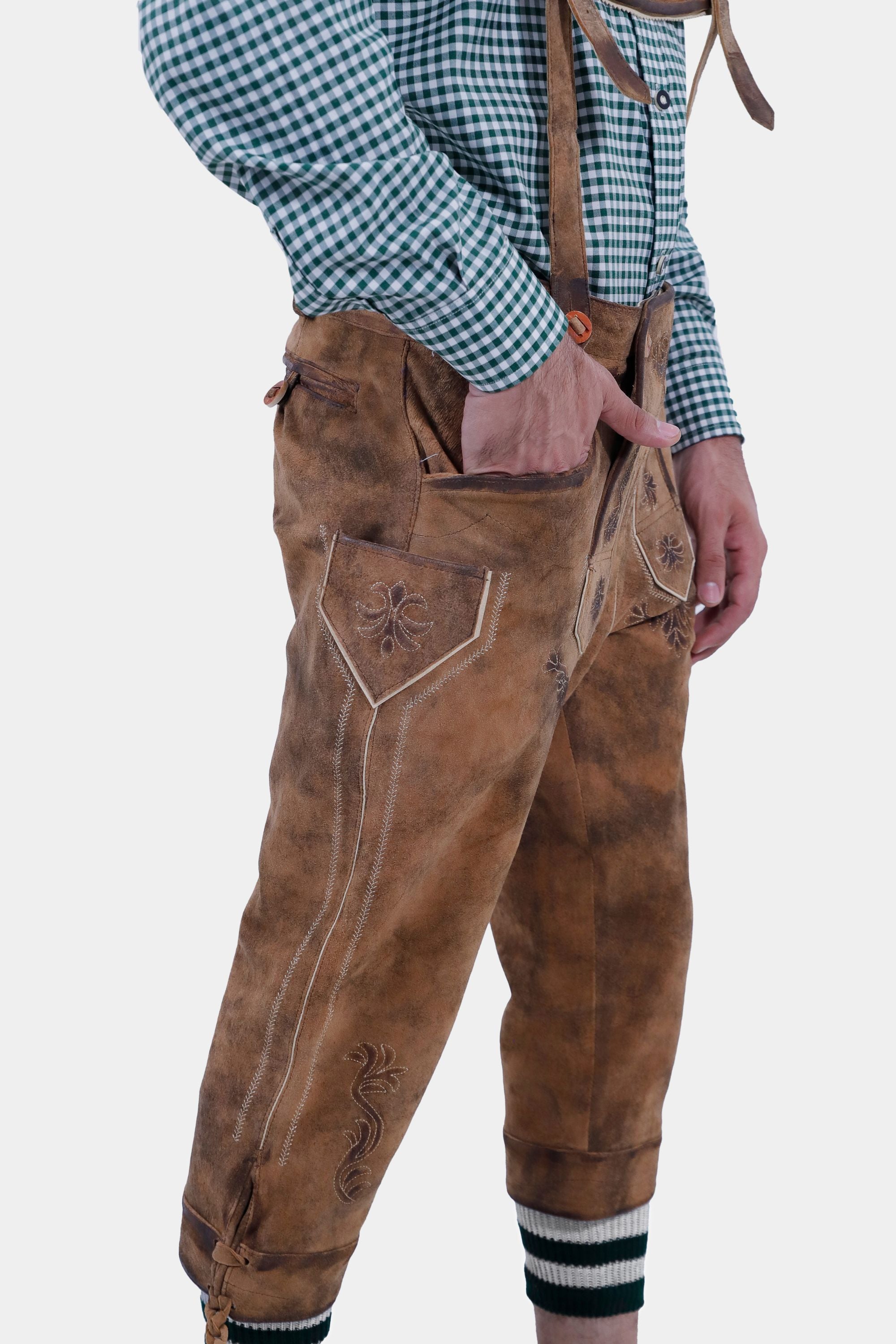 Side view of a man wearing a light blue checkered shirt and Acropolis german Bundhosen, showing the detailed embroidery on the Bundhosen.