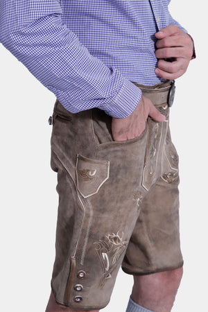 Side view of a man wearing Traditional Bavarian lederhosen, featuring intricate embroidery and front flap pockets, perfect for Oktoberfest celebrations and cultural events