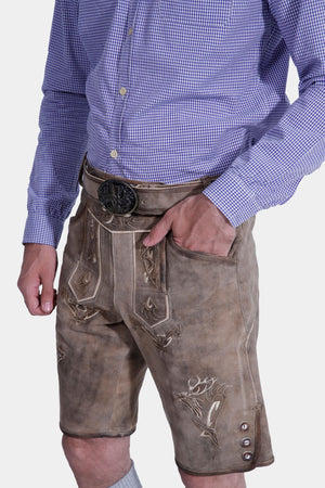 Side view of a man wearing Traditional Bavarian lederhosen, featuring intricate embroidery and front flap pockets, perfect for Oktoberfest celebrations and cultural events