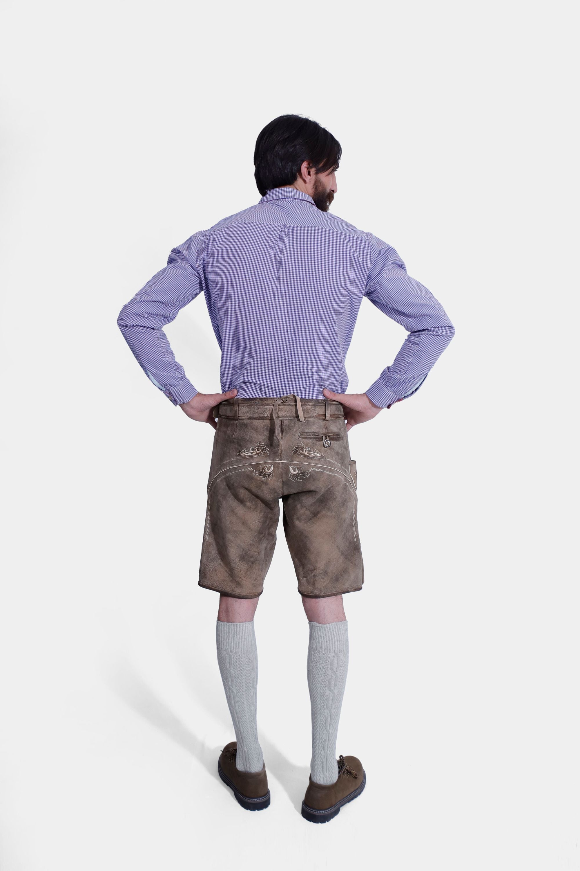 Rear view of a man wearing Traditional Bavarian lederhosen, featuring intricate embroidery on the suspenders and front flap pockets, perfect for Oktoberfest celebrations and cultural events