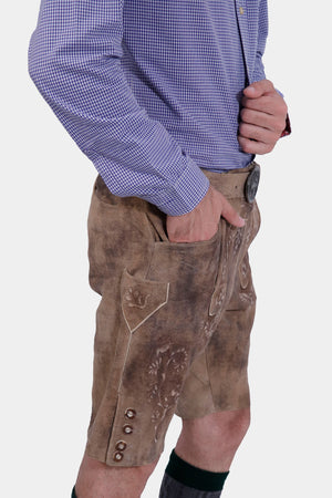 Side view of the man wearing the Alpine Eagle Lederhosen, displaying the knife pocket and detailed embroidery on the legs.