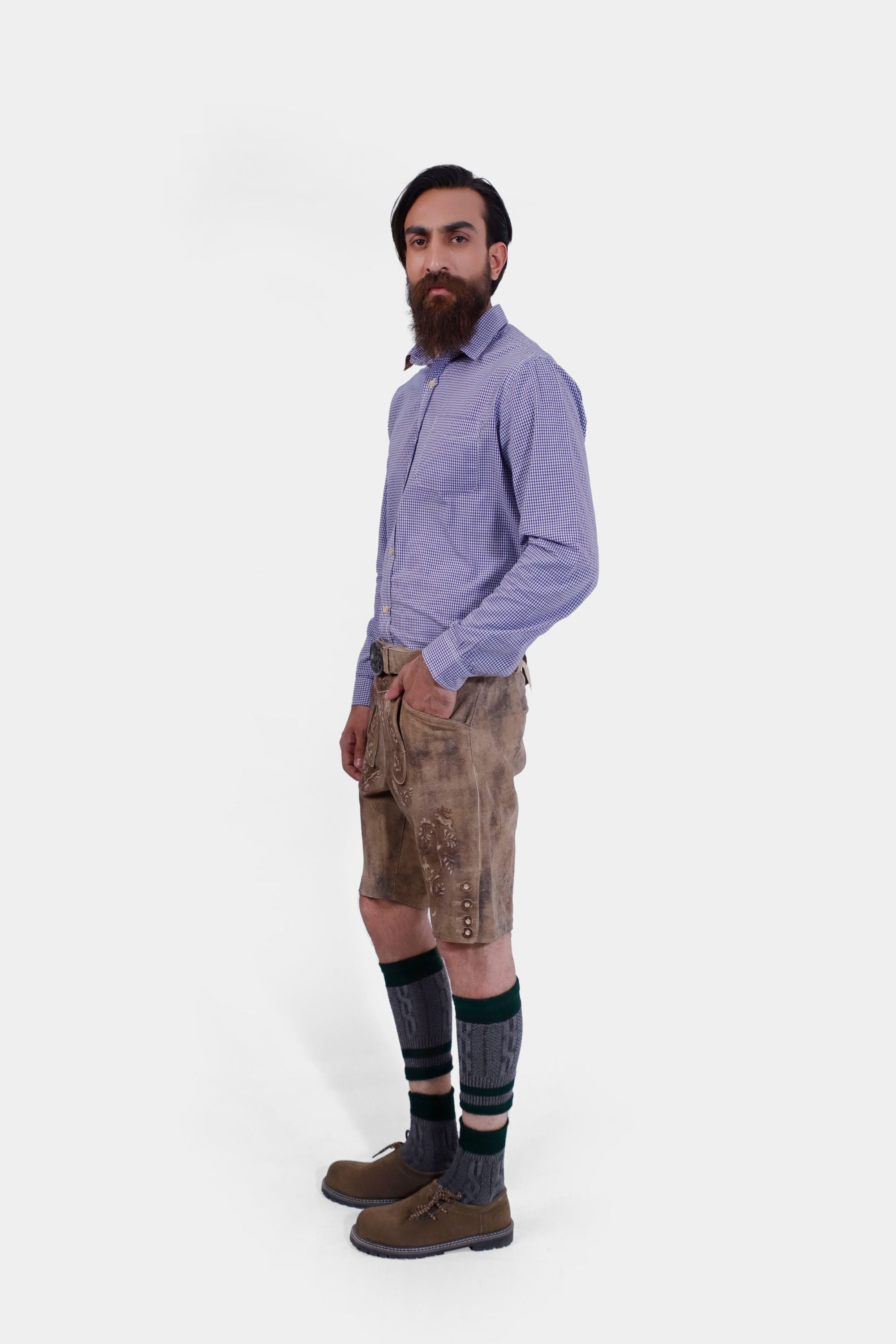 The man wearing the Alpine Eagle Lederhosen with a close-up on the waistband, showing the detailed buckle and leather texture.