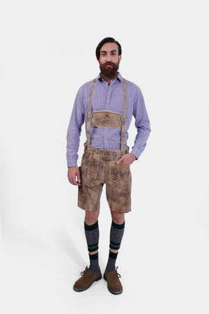 The man wearing the Alpine Eagle Lederhosen, standing in a side pose, displaying the fit and craftsmanship of the lederhosen.
