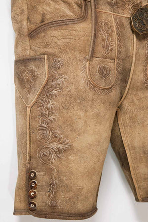 Side view of mens Oktoberfest shorts highlighting the fine leather texture and ornate embroidery along the leg seams. These German lederhosen shorts provide comfort and tradition in one stylish package