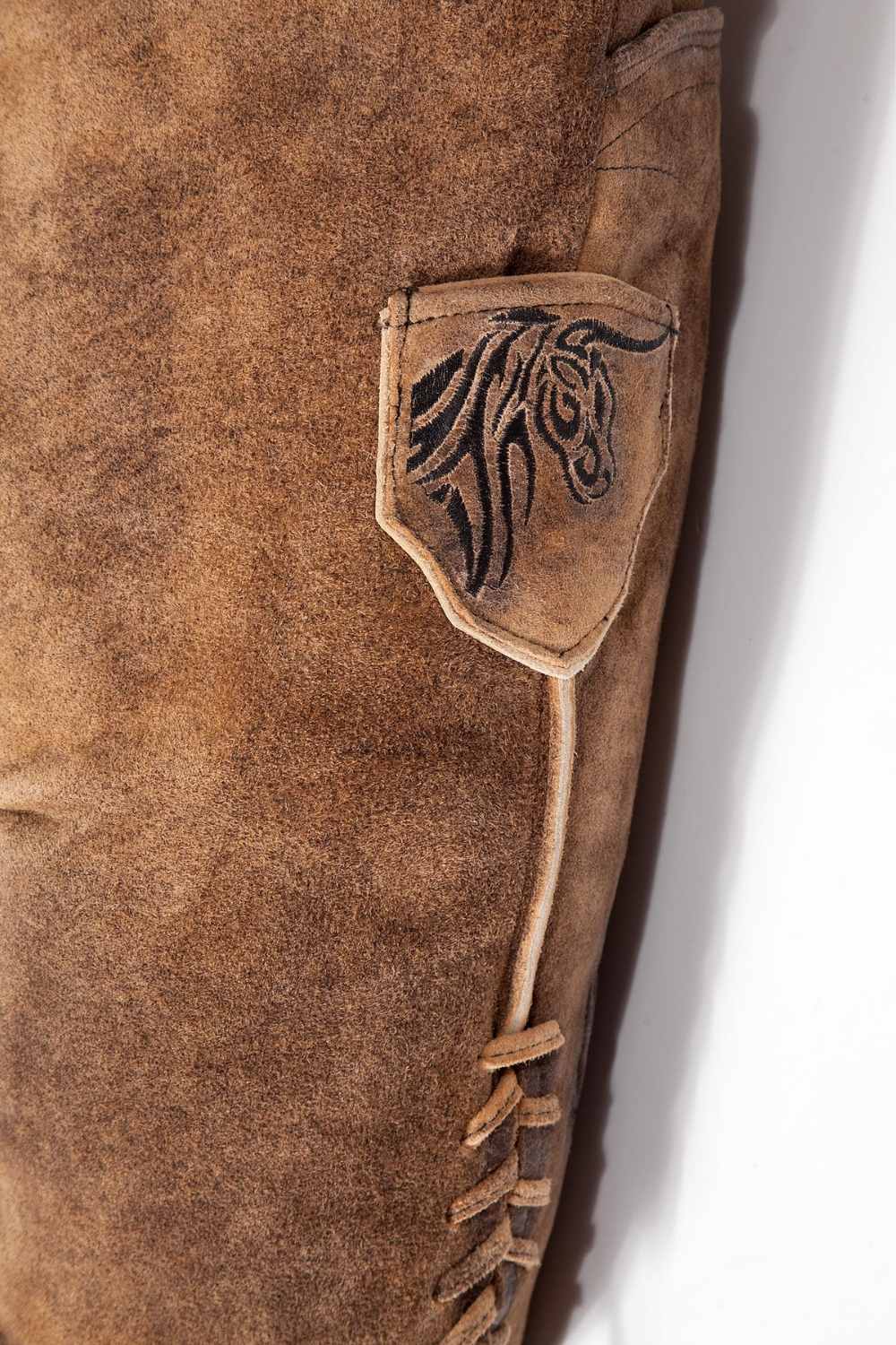 Side pocket view of mens lederhosen shorts showcasing fine leather texture and embroidered details, providing both style and practicality. These mens short lederhosen blend tradition with modern comfort.