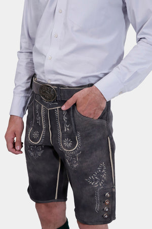 Close-up of the Black Forest Lederhosen showcasing the detailed embroidery and buttoned pockets.