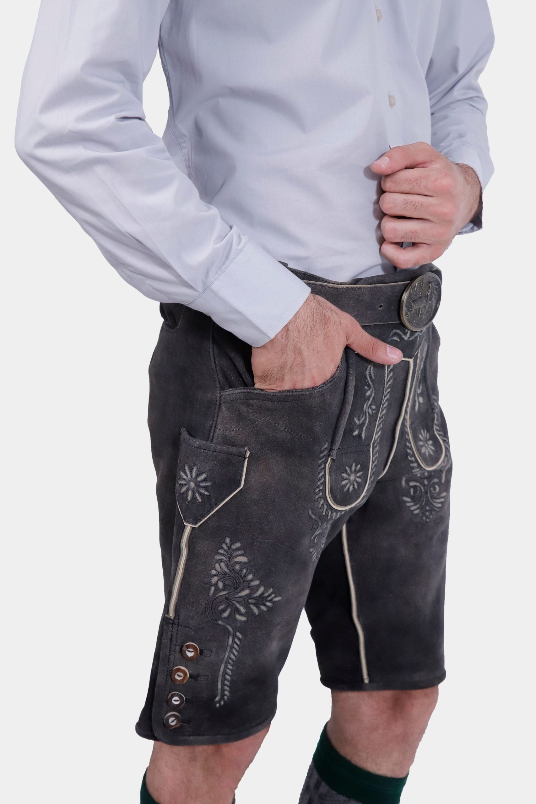 closed side view a bearded man standing confidently in Black Forest Lederhosen