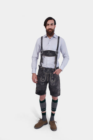Full front view of the man in Black Forest Lederhosen, exuding a classic Bavarian look with knee-high socks and brown shoes.