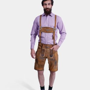 A man wearing traditional Bavarian Lederhosen. He is dressed in a purple long-sleeve shirt and light brown leather shorts with intricate brown embroidery and suspenders. The outfit is completed with dark gray socks and brown shoes, showcasing a classic Bavarian style.
