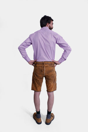 Rear view of a man in Brecht Classic Lederhosen, Burnished Bronze with intricate embroidery and stylish buttons.