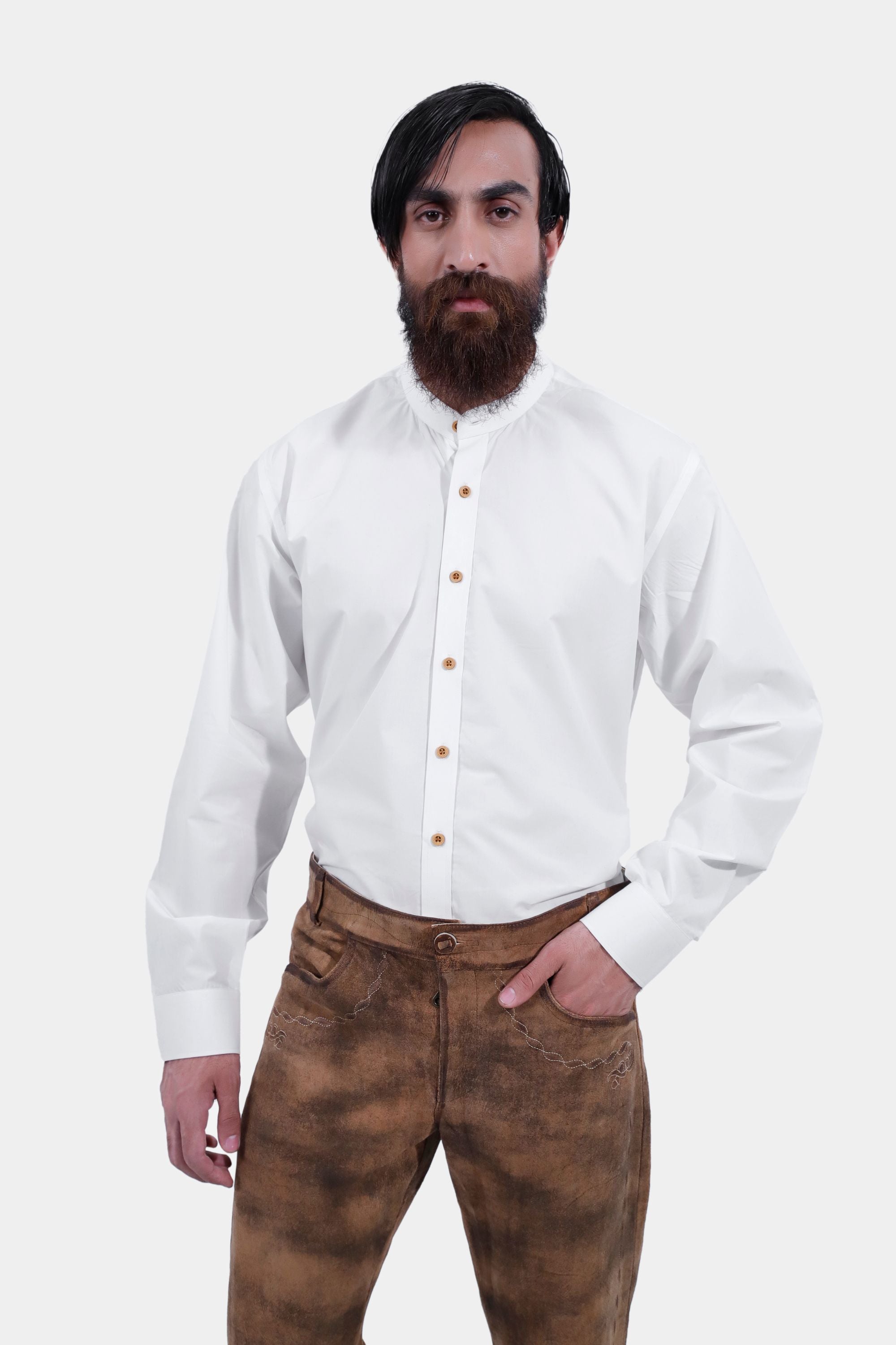 closed front view of a man wearing traditional lederhosen long pants with intricate embroidery paired with a plain white shirt