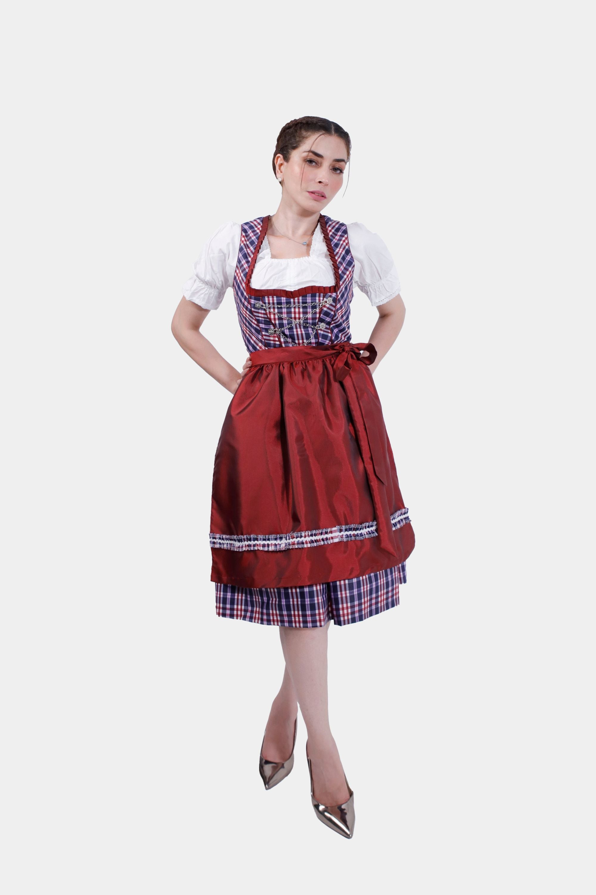 A full-length side view of the model in a traditional dirndl dress with a red apron, plaid skirt, and metallic high heels