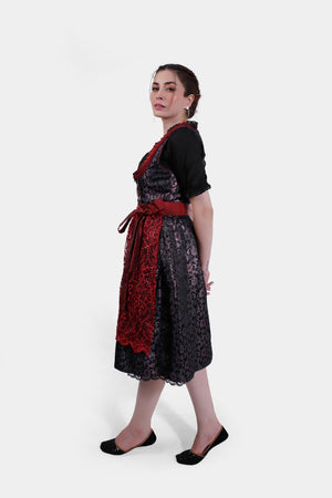 Another side profile of the woman in the dirndl, with a focus on the intricate lace apron and the overall elegance of the traditional outfit.