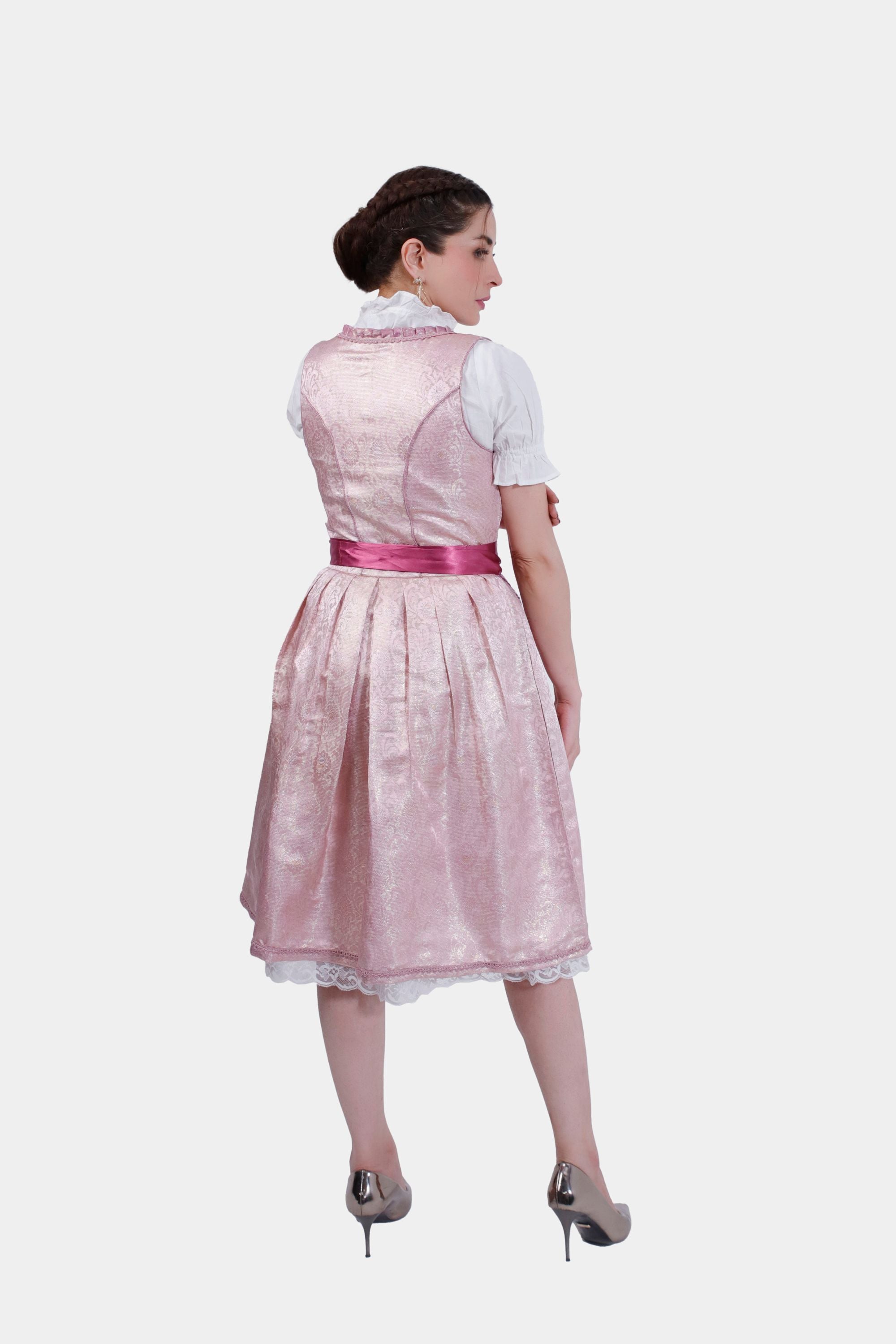 Back view of the pink dirndl dress showing the pleated skirt and satin ribbon tied in a bow around the waist.