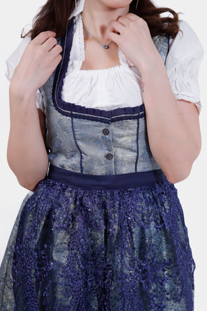 Close-up of the Dirndl's bodice, highlighting the intricate silver and blue fabric with decorative buttons and a detailed neckline.