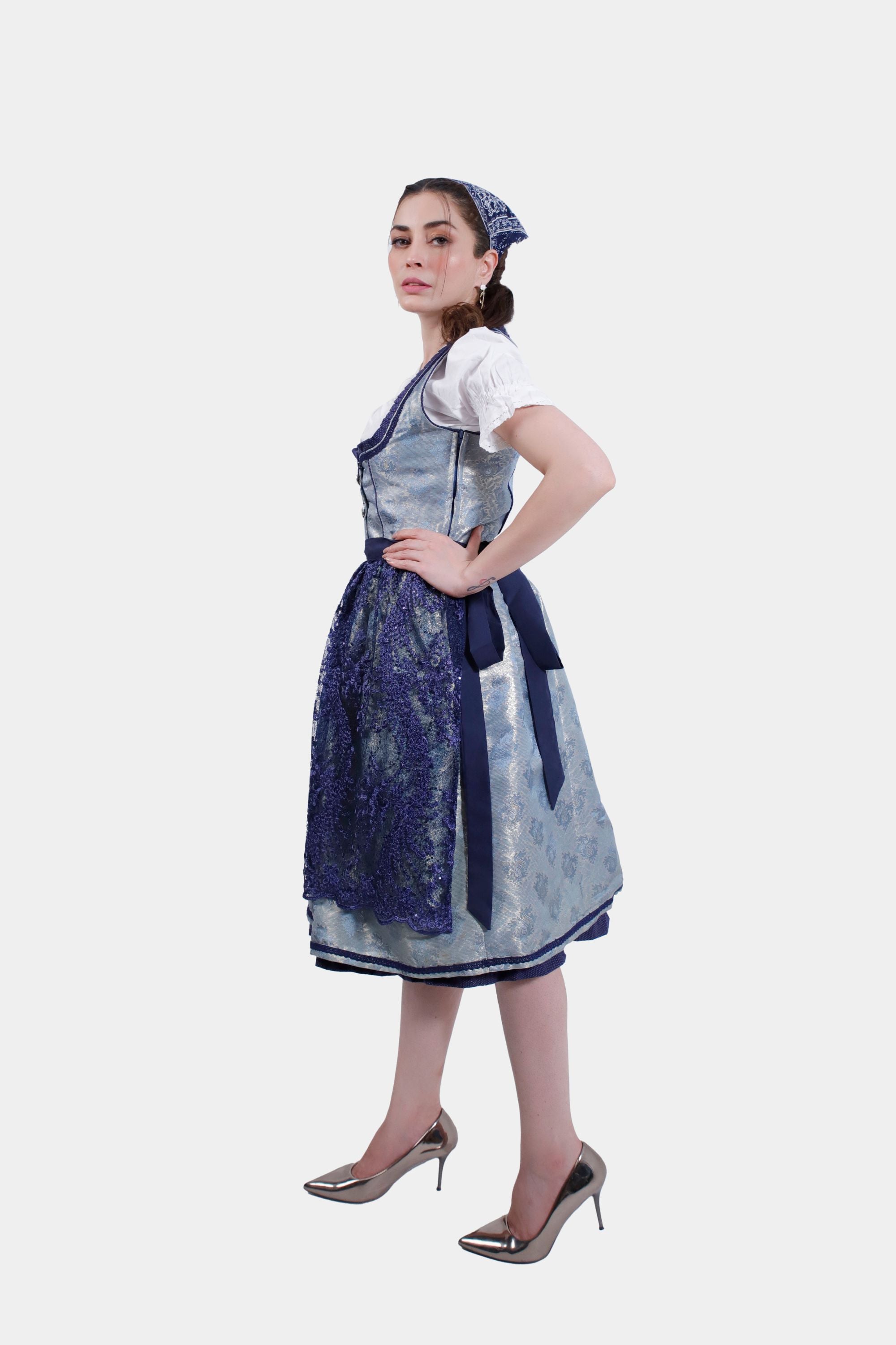 Side profile of the woman in the Dirndl dress, hands on hips, emphasizing the tailored fit and flowing skirt.