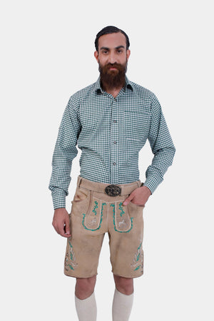 Man wearing traditional Lederhosen with green checkered shirt, light brown leather suspenders featuring green embroidery with deer motifs, named 'Edersee Wood Suspender.