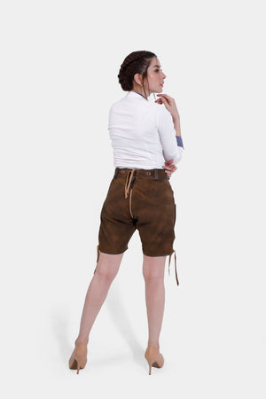 A rear view of a woman wearing earthy brown lederhosen with a white shirt, showcasing the back design of the lederhosen, paired with beige heels.