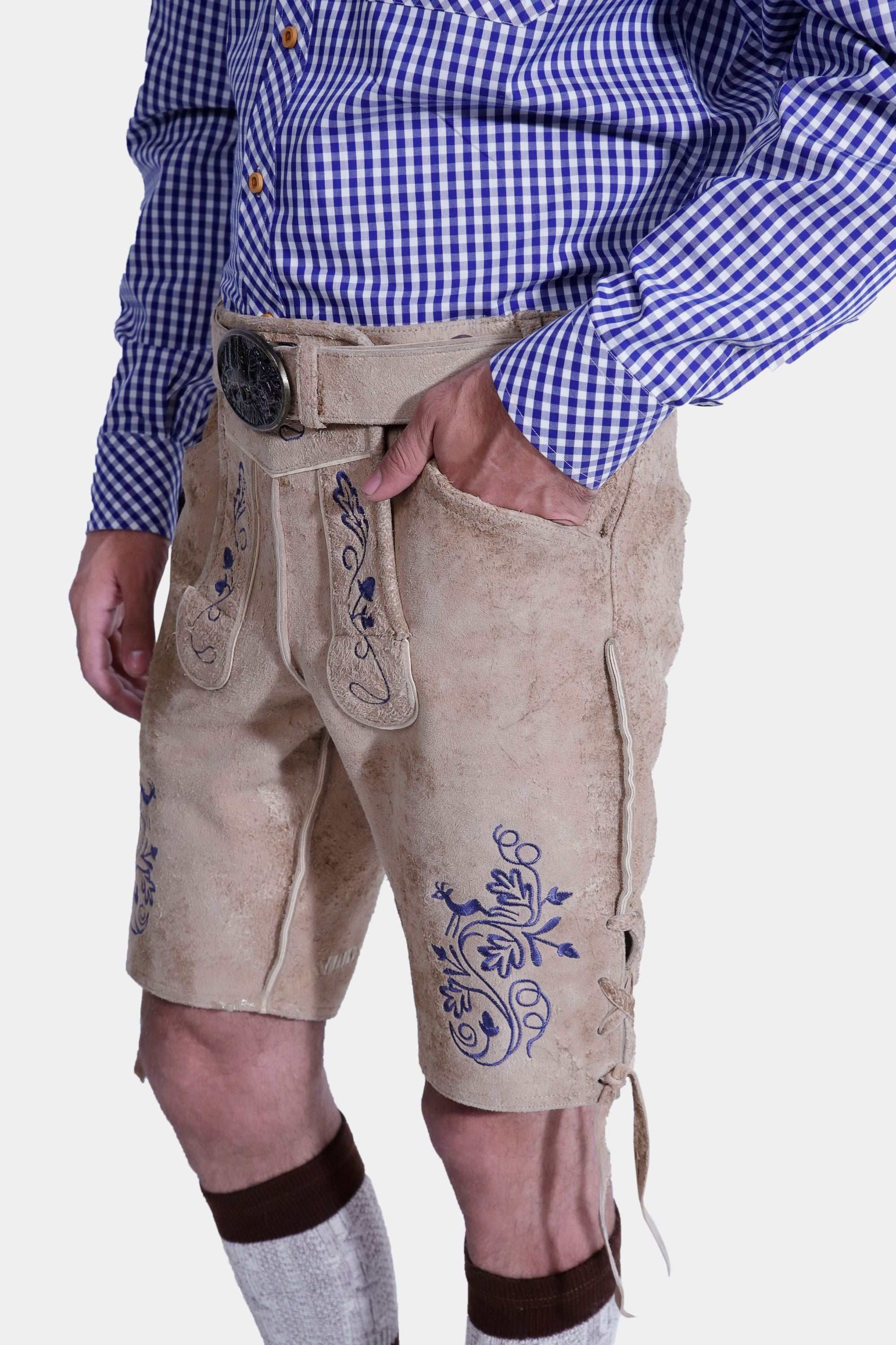 Man in light beige lederhosen with blue embroidery, front and back pockets, and a side knife pocket
